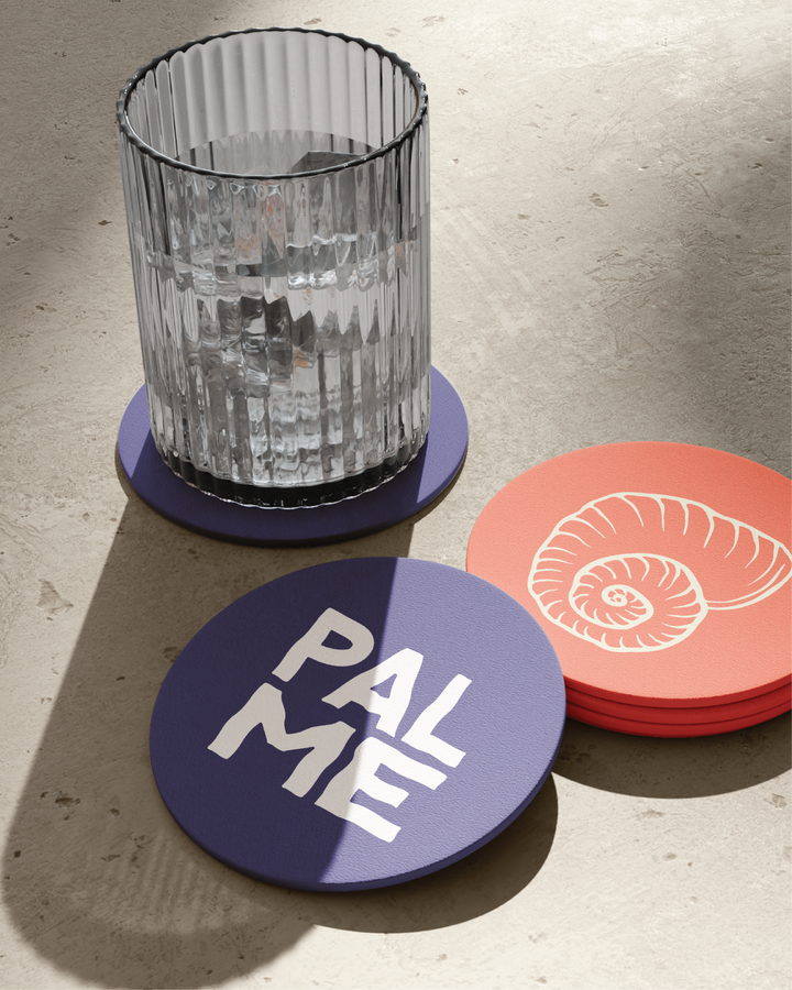 Branded cup with coasters featuring logo variations and custom illustrations by Ondas Creative.