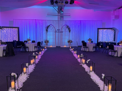 lighting wedding reception ceremony aisle archway candles indoor