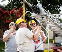 David Gilpin, K5GIL, Tom Yenny, K5LOL, and Austin Litman, N4AKL, mount the 6-meter Moxon.