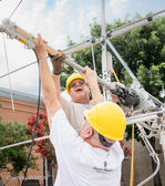 Tom Yenny, K5LOL, and Austin Litman, N4AKL, slide the 2 meter / 70 cm antenn on the top mast.