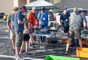 Canopies set up in the parking lot with items for sale.