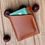 Thumbnail: Vertical card wallet (2 pocket) in folded chestnut hide with orange stitching