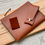 Thumbnail: Zipper folio in chestnut hide lined with blue Italian nappa leather