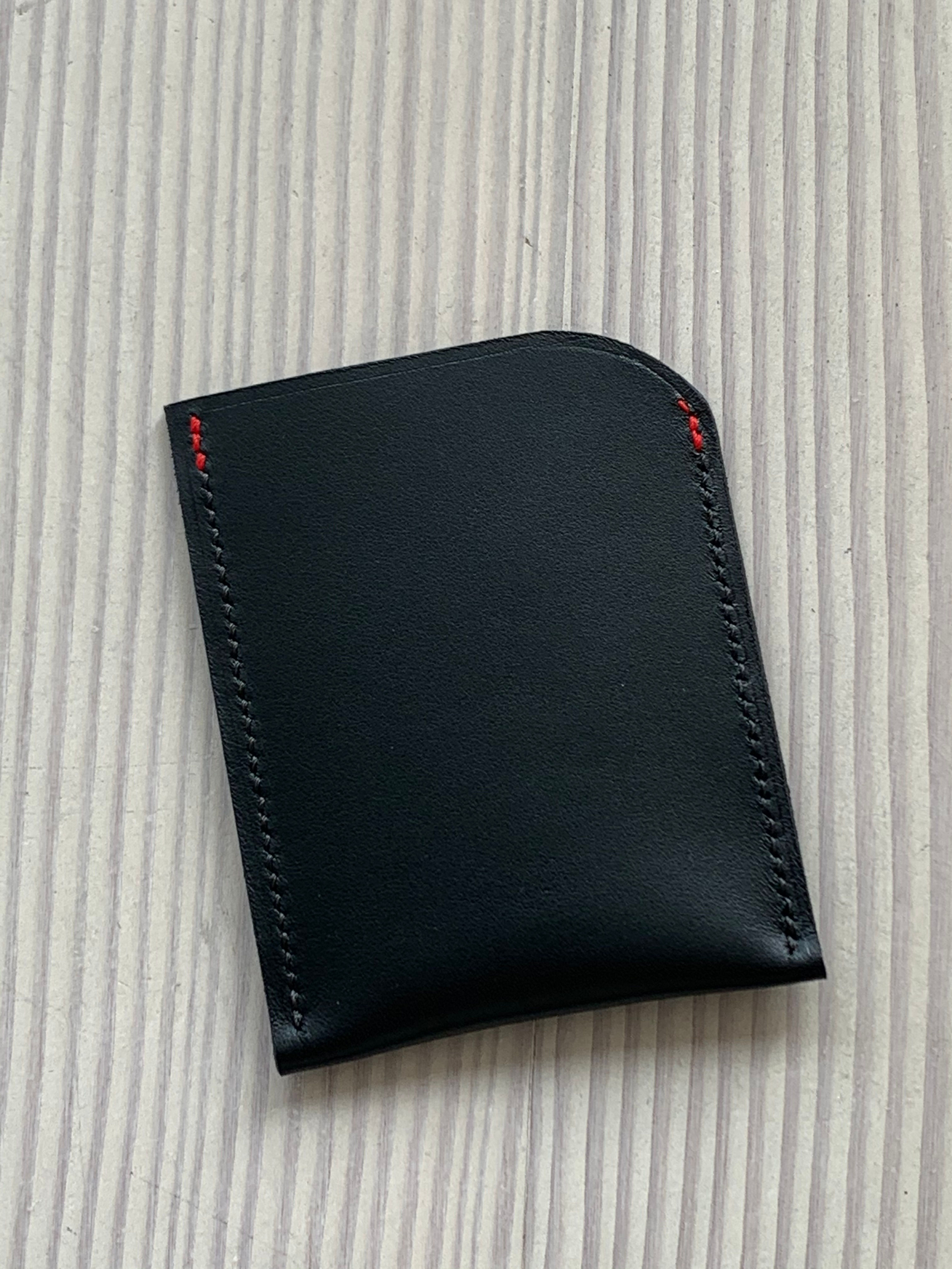 Card wallet (single pocket) in black calf with small red stitching accents