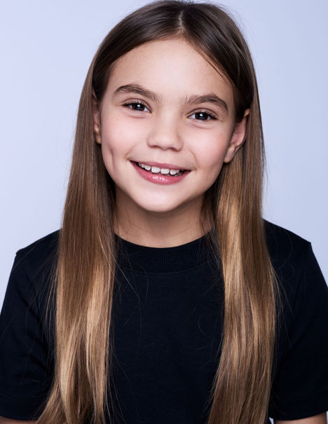 Child model headshot photography captured in Brisbane, featuring natural expression, soft light and a clean background by Jill – Eyes On You Photography