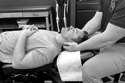 Dr. Taylor Baird evaluating a patients neck