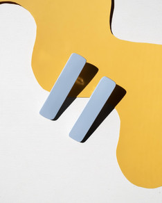 Light blue hair clips on yellow backgrou
