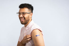 A man looking cheerful after being vaccinated for the flu