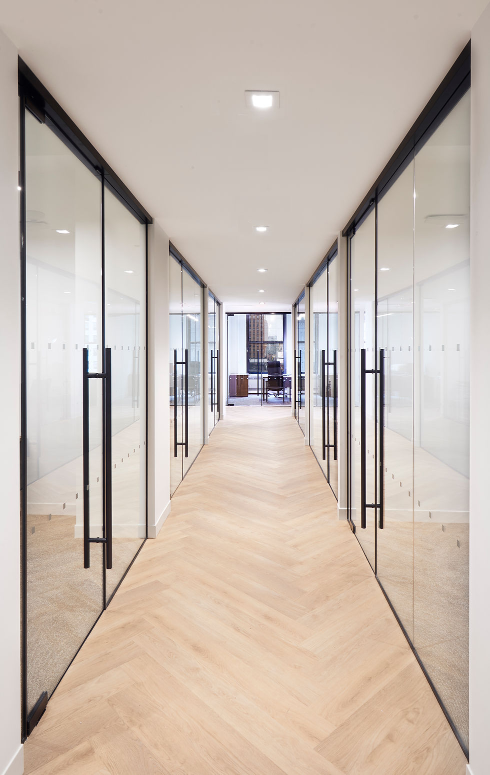 Office hallway with glass partitions and dark hardware, near Penn Station NYC commercial photography