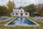 Modern farmhouse with pool and black fencing at dusk, Hudson Valley NY residential photography