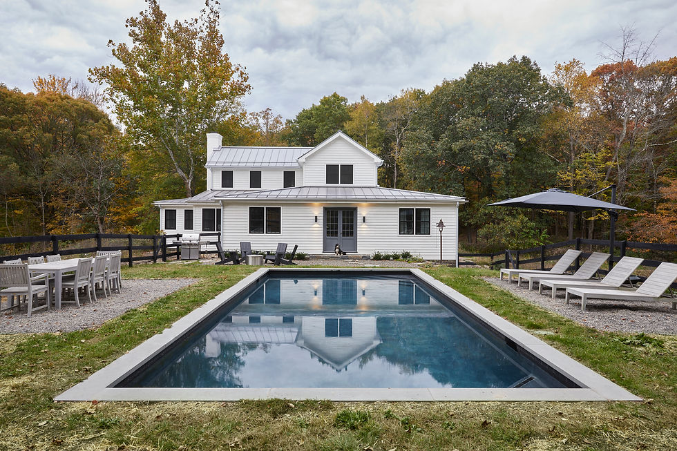 Modern farmhouse with pool and black fencing at dusk, Hudson Valley NY residential photography