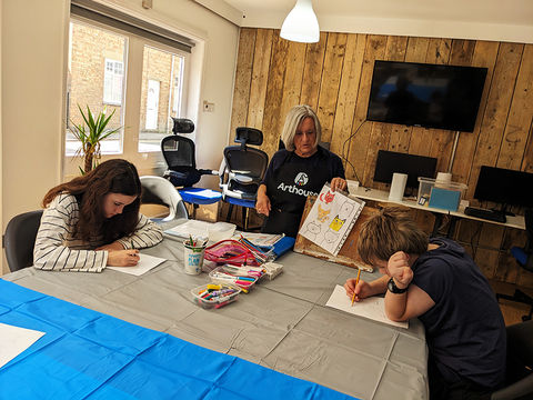 Teen students working on drawings during an Arthouse art class in Long Buckby