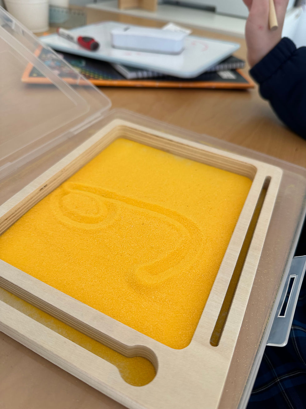 Sand tray with letter forms, literacy learning tool