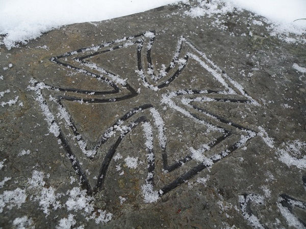 iron cross carved in rock on the scharnhorst memorial in botn norway