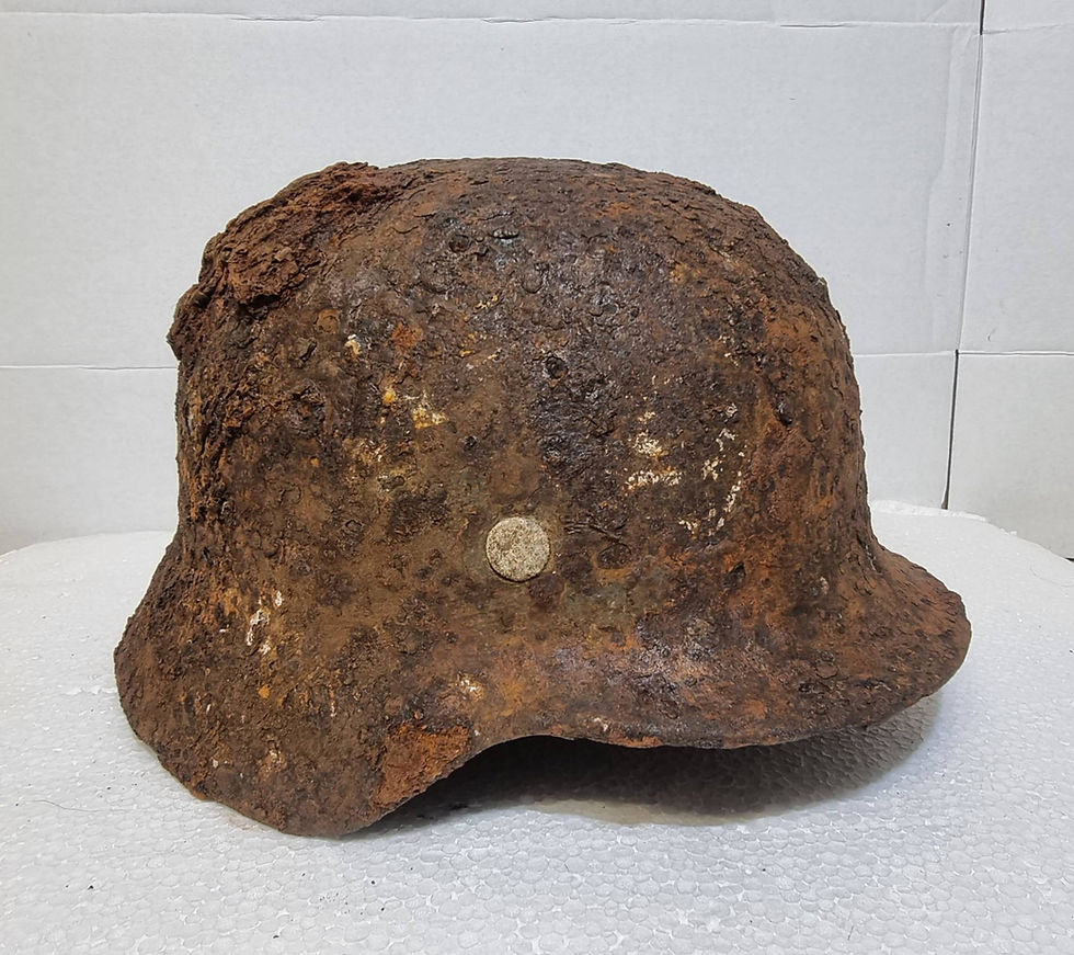 rusted german helmet with potential winter camo showing