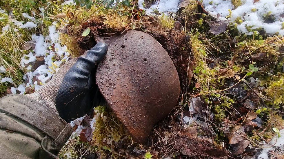 german helmet being pulled out of the ground
