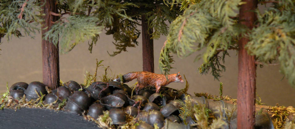 a fox on a pile of rusted german helmets