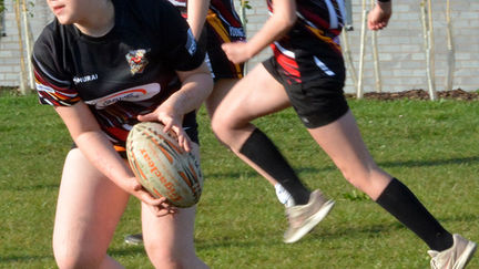 Youth girls rugby team sponsored by Game Guard practising with gumshields, highlighting durability and protection