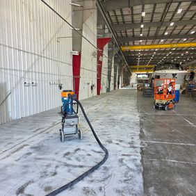 Concrete floor grinding and surface preparation for commercial coating removal in Florida.