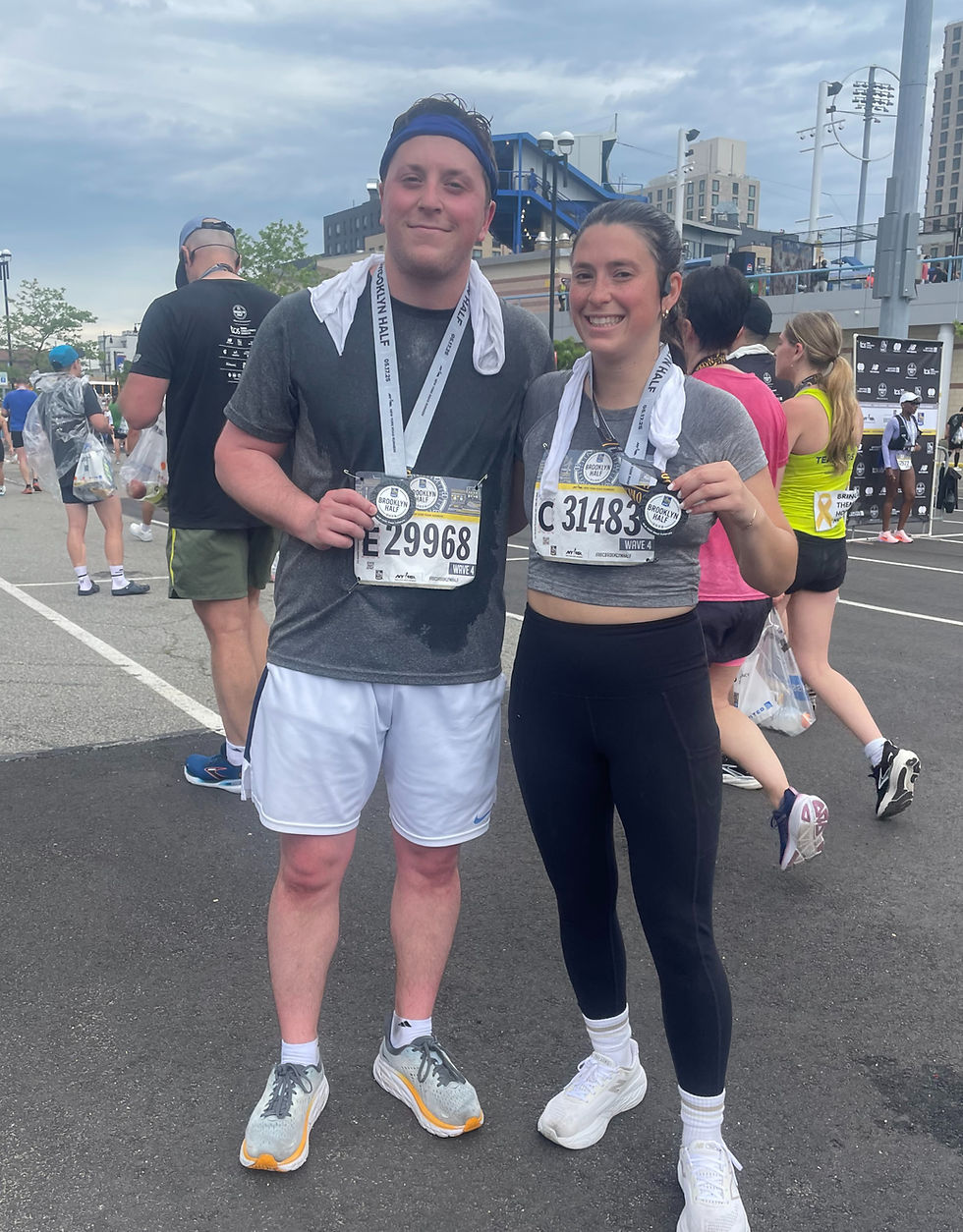 Michael Bussinelli and his sister after an organized run displaying their medals