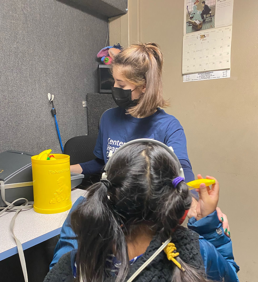 CHC-NY Audiologist Dominique Calandrillo screens the hearing of a child as part of Project PATH, Preschool Access to Hearing