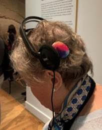 Ruth Bernstein demonstrates hearing access at the Me using a headphone in combination with her cochlear implant