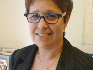 CHC Executive Director Laurie Hanin's headshot showing her smiling, in glasses and wearing a navy blazer