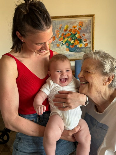 Ruth Bernstein with 4-month old great-grandson and his mom, all smiling in close-up