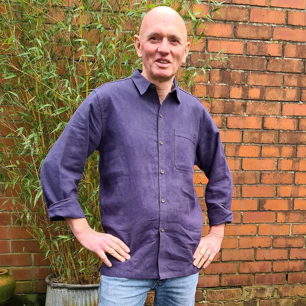 Thumbnail: man standing in front of bamboo wearing dark mauve collared long sleeved shirt with buttoned front
