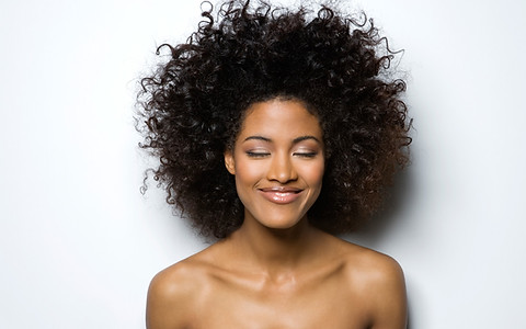 Portrait of a Smiling Woman with Curly H