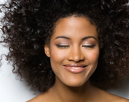 Smiling black woman with curly hair