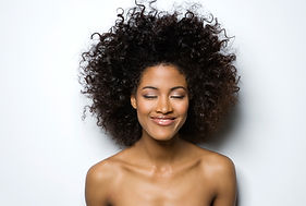 Portrait of a Smiling Woman with Curly H