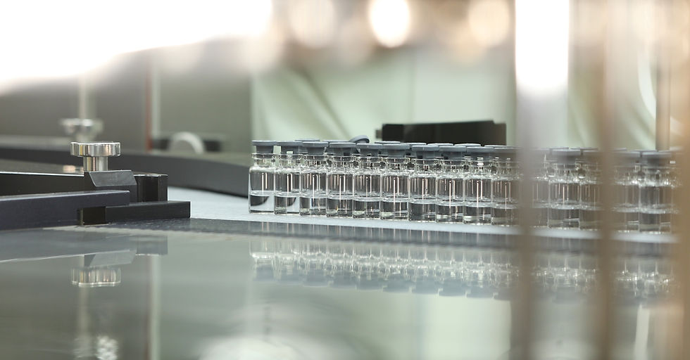 A lot of liquid vaccine medicine filled glass injection vials entering into lyophilization