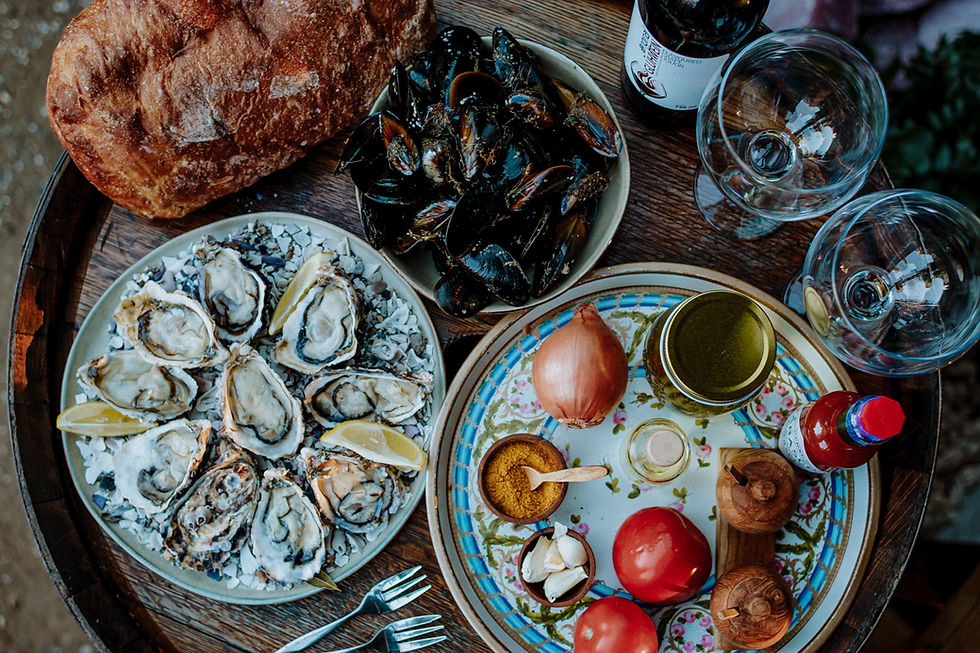Seafood platter with oysters, tomatoes, and sauces