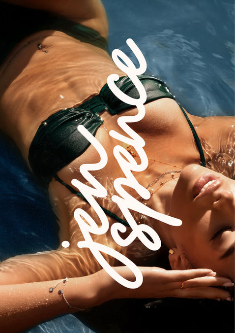 A woman lies in a pool in a black bikini, the shot is taken from above. On top of the image is white text that reads 'jen spence' in a handwritten cursive font.