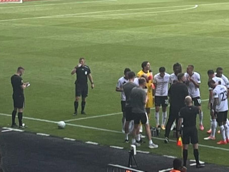 John Eustace gives his players instructions during a hydration break.