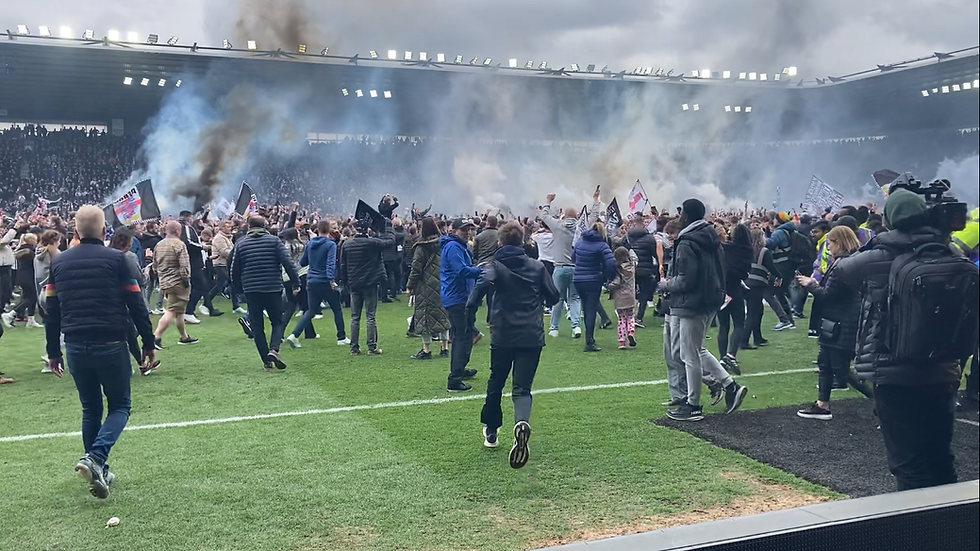 Fans invaded the pitch as they celebrate promotion.