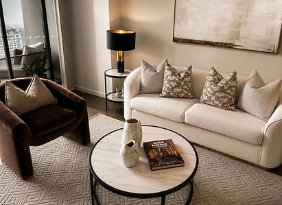 5. Designer apartment kitchen and living space styled with warm neutral tones, premium furnishings and timeless contemporary décor.
