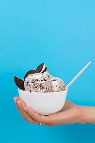 hand-delicious-ice-cream-with-cookies-side-view.jpg