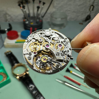Roger Dubuis chronograph movement during an overhaul by a watchmaker in the watchmaking workshop.