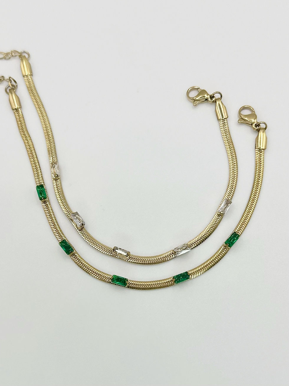 Thumbnail: Sleek Gold Snake Chain With Emerald Sparkle Detail Bracelet