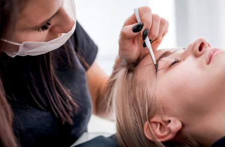 model being prepared for permanent makeup