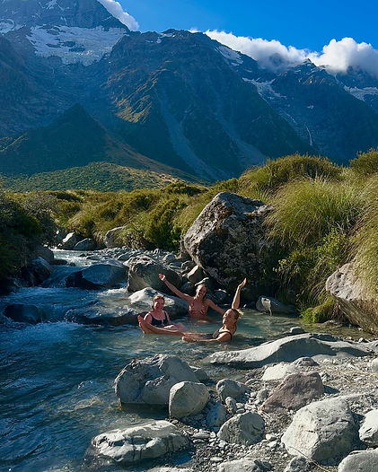 A group of women relaxing in a river during hiking session in New Zealand