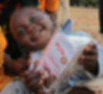 Child holding Kit Yamoyo