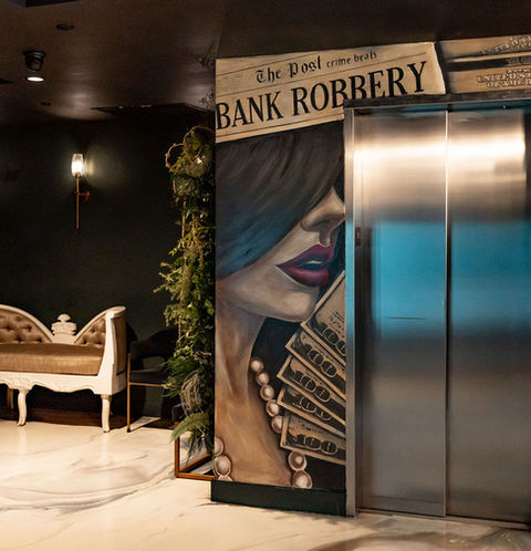 Elevator with bank robbery mural and text. Walkthrough the luxury lobby area. Strickland's