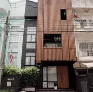 modern facade townhouse Phnom Penh minimalist exterior wood slat design