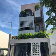 modern facade townhouse Phnom Penh minimalist exterior wood slat design