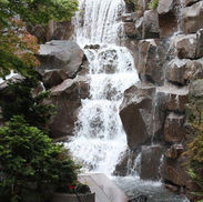 Large outdoor rock waterfall with natural stone and cascading water