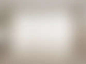 Living room with floor-length sheer curtains hung high near the ceiling, demonstrating correct curtain height for a taller, more balanced space.