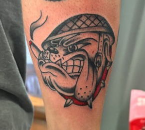 Traditional bulldog tattoo with helmet and cigar on arm